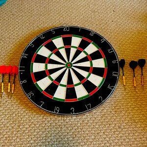 Used dart board. $22 cheaper.New price is $15! Includes darts.